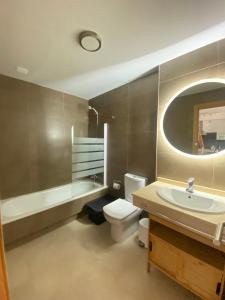 a bathroom with a sink and a toilet and a tub at Cozy 1 Bedroom Apartment with Sea View in Cotillo