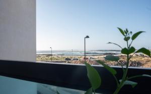 a window with a view of the beach at Cozy 1 Bedroom Apartment with Sea View in Cotillo