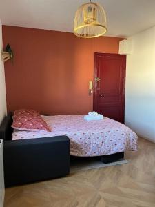 a bedroom with a bed and a red door at Studio - Cosy Kaza in Angers