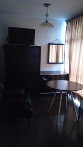 salon ze stołem, kanapą i telewizorem w obiekcie Alcoba en Polanco (solo hombres) w mieście Meksyk