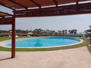 a large swimming pool in the middle of a yard at Depa de Playa en Asia in Asia