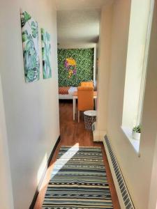 a hallway with a living room with a rug at Hip Studio w/City Views Minutes to DT in Calgary