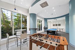 a living room with a pool table and ping pong ball at Hollywood Beach Ocean View Condo, Direct Beach Access, Pool & Resort Amenities in Hollywood