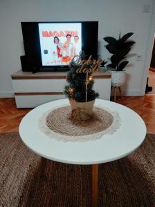 a white coffee table with a christmas tree on top of it at FRIENDLY HOME in Tuzla