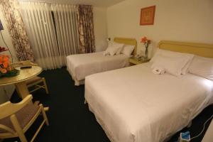 Postel nebo postele na pokoji v ubytování Plaza Mayor Hotel