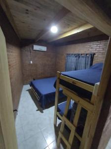 a small room with two beds and a table at Finca La Huella II in Santiago del Estero +22 photos