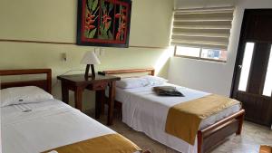 Postel nebo postele na pokoji v ubytování Hotel Tayrona