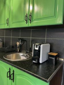 a kitchen counter with a coffee maker on a counter top at Mountain apartment ''Michelle'' in Kakanj