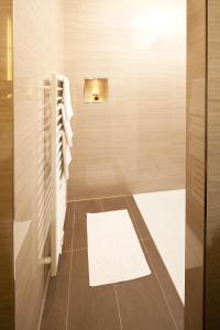 a bathroom with a shower with a white towel at Hotel Hoher Freschen in Rankweil