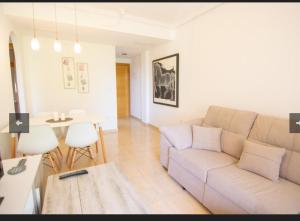 a living room with a couch and a table at Apartamento Galea in Santa Pola