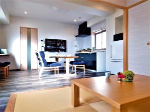 a kitchen and living room with a table and chairs at GLANZ KEI Kyoto Station in Kyoto