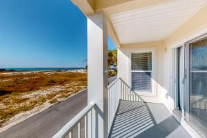 a balcony of a house with a view of the ocean at Gulf Island 412 in Navarre