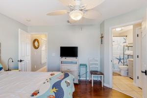 a bedroom with a bed and a flat screen tv at Gulf Island 412 in Navarre