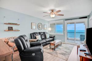 a living room with a couch and a ceiling fan at 306 Coral Sands in Fernandina Beach