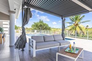 a living room with a couch and a table at VILLA MELINA in Cadet