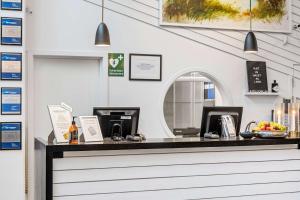 a cash counter in a restaurant with a mirror at Best Western Hotel Corallen in Oskarshamn