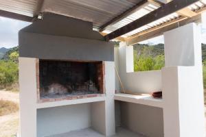 an outdoor pizza oven with a view of the mountains at Cederkloof Botanical Retreat in Citrusdal