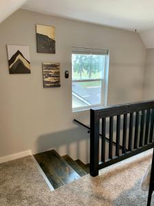 a room with a staircase and a window at A Cozy Place to Land in Salem