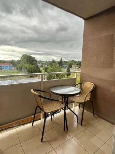 a balcony with a table and chairs and a view at Brisas del sur in Osorno