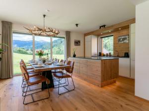 a kitchen with a table and chairs and a large window at Mountain Vista in Sankt Lorenzen ob Murau