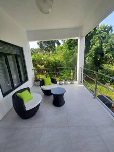 a patio with couches and chairs on a balcony at The Willow Apartment in Clifton Falls