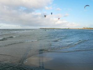 um grupo de pessoas soltando pipas sobre o oceano em 5 star holiday home in Wendtorf em Wendtorf