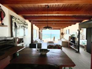 a living room with a table and a view of the ocean at Mirada al Mar in Matanzas