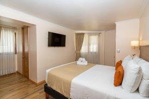 Postel nebo postele na pokoji v ubytování Tagle Hotel Boutique