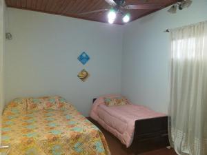 a bedroom with two beds and a window at Mer Departamento in Resistencia
