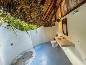 a bathroom with a toilet and a sink at Hotel Playa Bonita Tayrona in Buritaca +128 photos