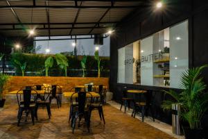a restaurant with tables and chairs in front of a building at Berry Biz Hotel Sunset Road in Seminyak