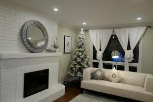 a living room with a christmas tree and a fireplace at Le Boutique Great Toronto in Mississauga