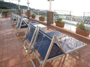 a row of blue chairs sitting on a roof at Hotel Dania in Sorrento