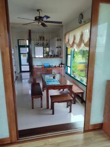 a kitchen and dining room with a table and chairs at Meet Bay B&B in Xiyu