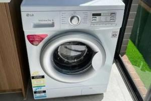 a white washing machine sitting in a room at Entire 4 Bedroom Brand New Home In Melton South ! in Melton South