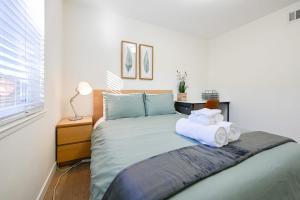 um quarto com uma cama com toalhas em @ Marbella Lane - Exquisite Home 3BR em Sunnyvale