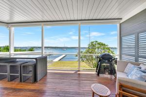 a screened in porch with a view of the water at Valentine Views Lakefront Tranquility with Private Jetty in Toronto