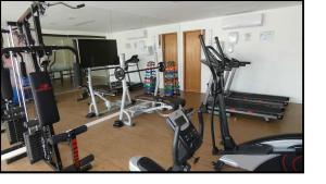 a gym with several exercise equipment in a room at Village Condomínio Porto Smeralda - Guarajuba in Guarajuba