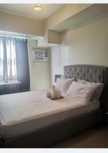 a bed with a pair of shoes sitting on it at Ghabian Property in Cebu City