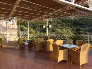a restaurant with tables and chairs on a patio at Hotel Dania in Sorrento