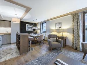 a living room with a kitchen and a dining room at Appartement Courchevel 1550, 3 pièces, 6 personnes - FR-1-562-64 in Courchevel