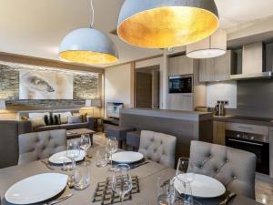 a dining room with a table and chairs at Bel appartement moderne, parking, WiFi, proche pistes - FR-1-562-64 in Courchevel