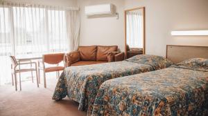 En eller flere senge i et værelse på Downtown Motel Warrnambool