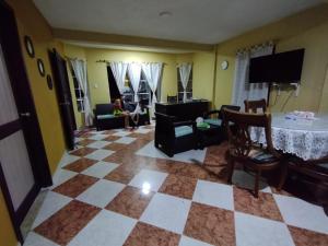 a living room with a checkered floor at POSADA NATIVA PALILLO´S PLACE in Franshua