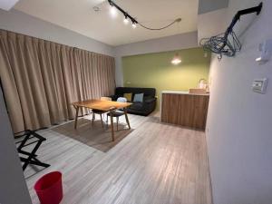 a living room with a table and a couch at IF Guest House in Tainan