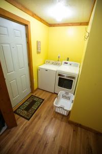 a small kitchen with a stove and a door at Climb On Inn - Red River Gorge Kentucky - Amazing Home ! 