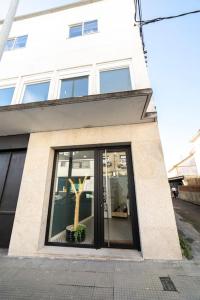 a building with a window with a tree in it at Amplio piso de diseño . in Vigo