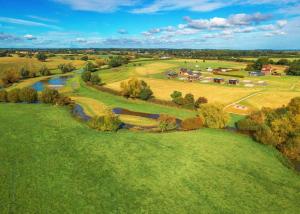 an aerial view of a field with a river at Bowbrook Lodges in Pershore