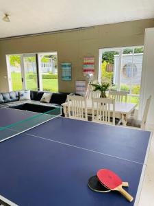 a ping pong table with a hat on it at Farm Stay HARMONY Cottage at Wilindi Estate in Tyabb