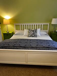 a bedroom with a large bed with two night stands at Unique Home Perfect for Large Gatherings. Pets welcome! in Orem